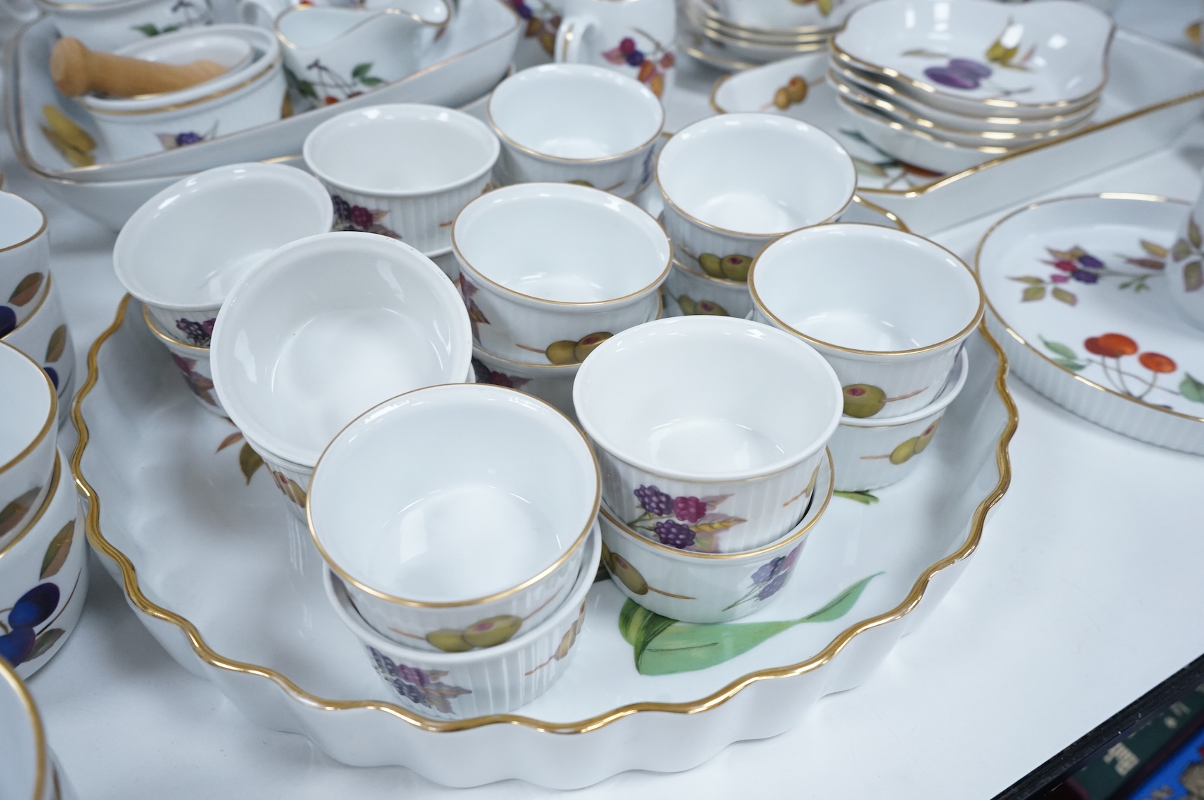 A collection of Royal Worcester Evesham tea and kitchen wares, including storage jars, casserole dishes and cover, flan dishes, serving dishes, tea cups and saucers etc.